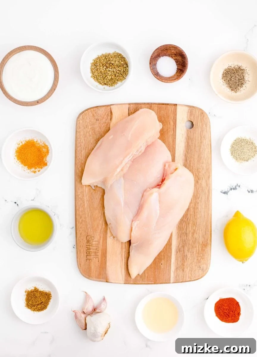 Mediterranean Chicken Wraps 3 the ingredients for chicken gyros are placed on a white surface.