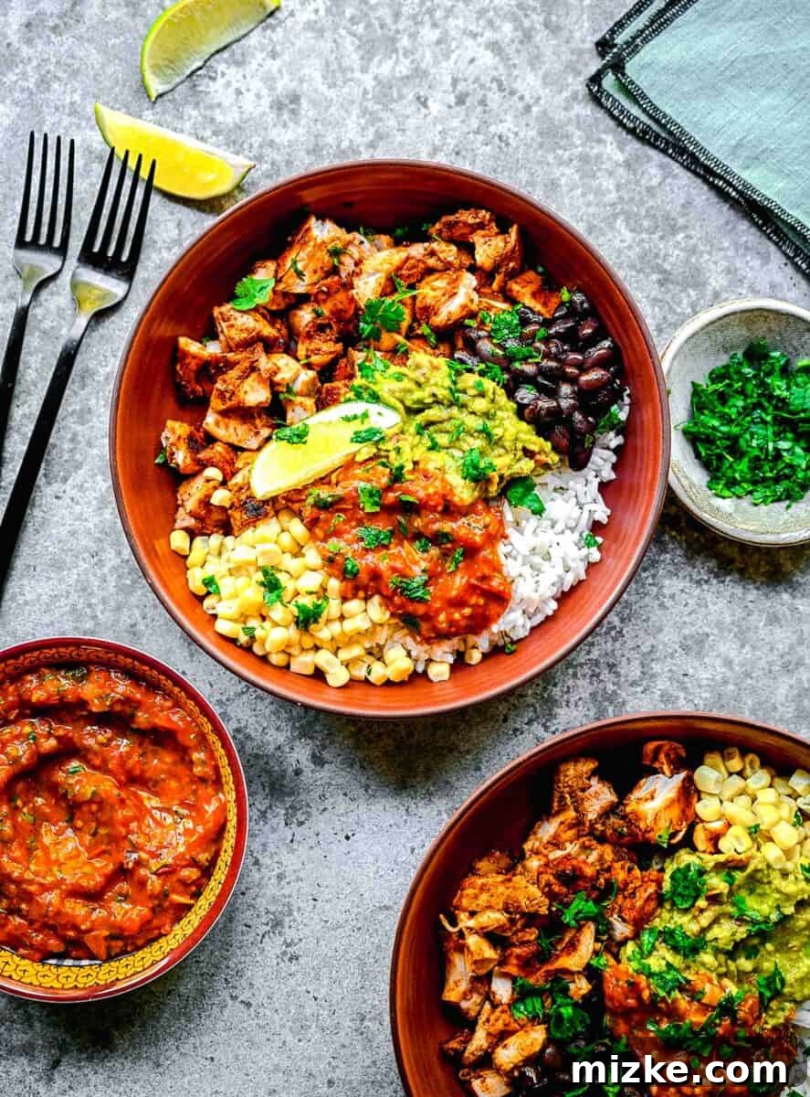 Smoky Chipotle Grilled Chicken 2 Two bowls are filled with a colorful array of toppings, succulent chicken, and fluffy rice, showcasing the versatility of Chipotle Chicken.