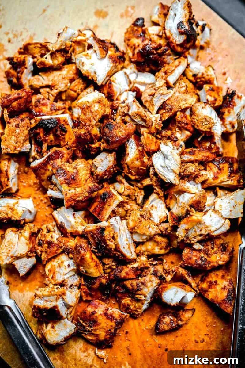 Smoky Chipotle Grilled Chicken 6 A cutting board is topped with perfectly grilled and expertly chopped chicken thighs, ready for assembly into a delicious meal.