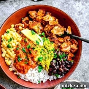 Smoky Chipotle Grilled Chicken 9 A vibrant, overflowing burrito bowl with Chipotle Chicken, fresh vegetables, and guacamole.