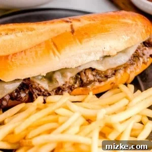 A French Dip sandwich with fries on a plate.