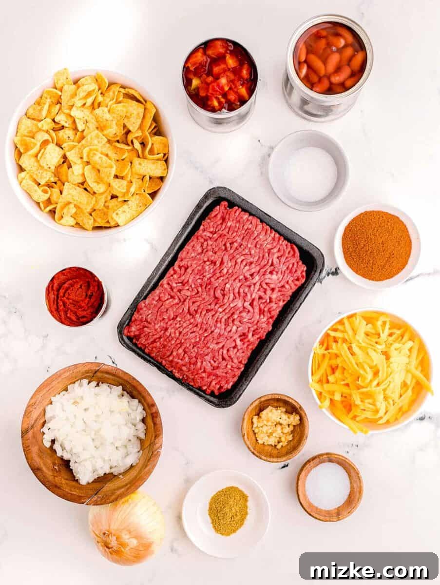 Ultimate Frito Chili Pie 3 The ingredients for frito chili pie are presented on a white surface.