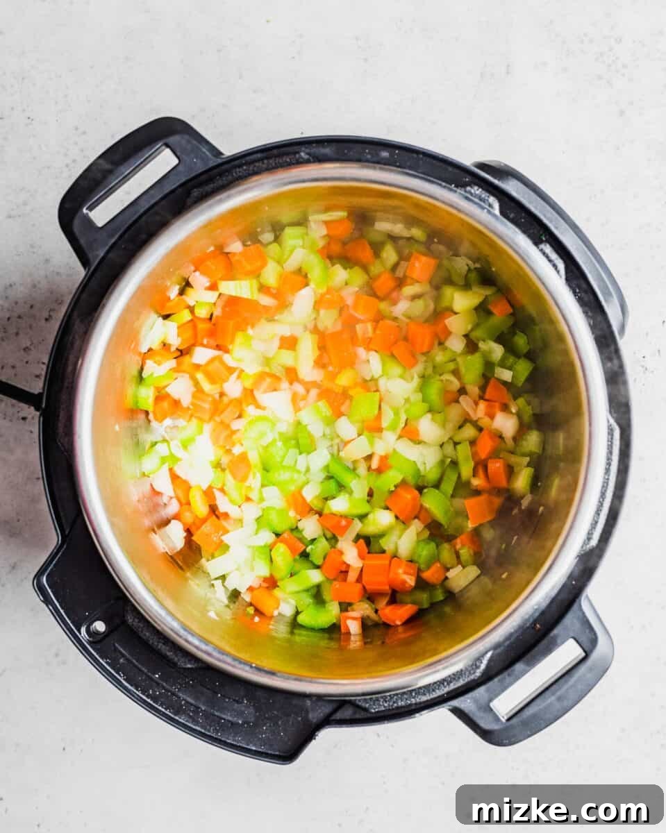 Fresh vegetables being gently sautéed in the Instant Pot, forming the flavorful base.