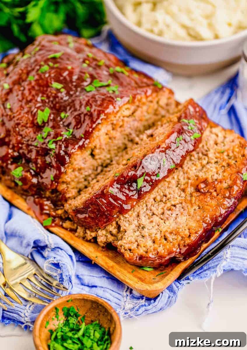 Perfect Instant Pot Meatloaf 2 A perfectly sliced Instant Pot Meatloaf on a rustic serving plate, garnished with fresh parsley, ready to be enjoyed.