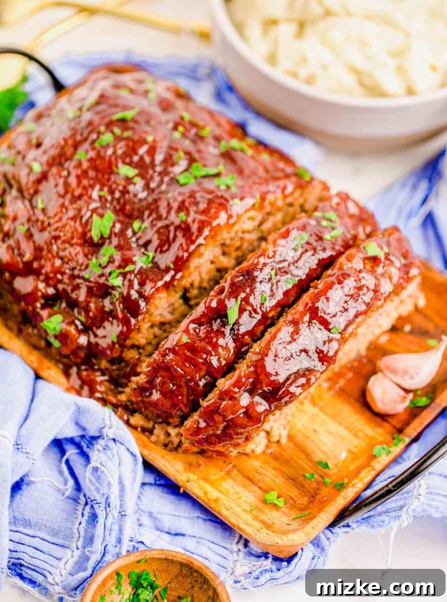 Perfect Instant Pot Meatloaf 12 A beautifully sliced and elegantly garnished Instant Pot meatloaf is presented on an elegant wooden serving plate, signaling its readiness to be enjoyed as a gourmet comfort meal.