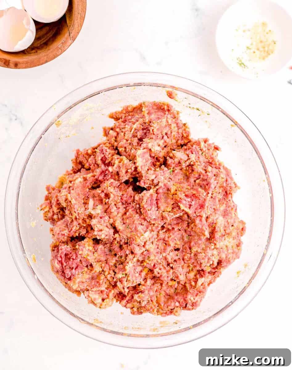 Perfect Instant Pot Meatloaf 5 The meatloaf ingredients have been thoroughly combined in a glass bowl, resulting in a uniform and well-mixed meat mixture, ready for shaping.