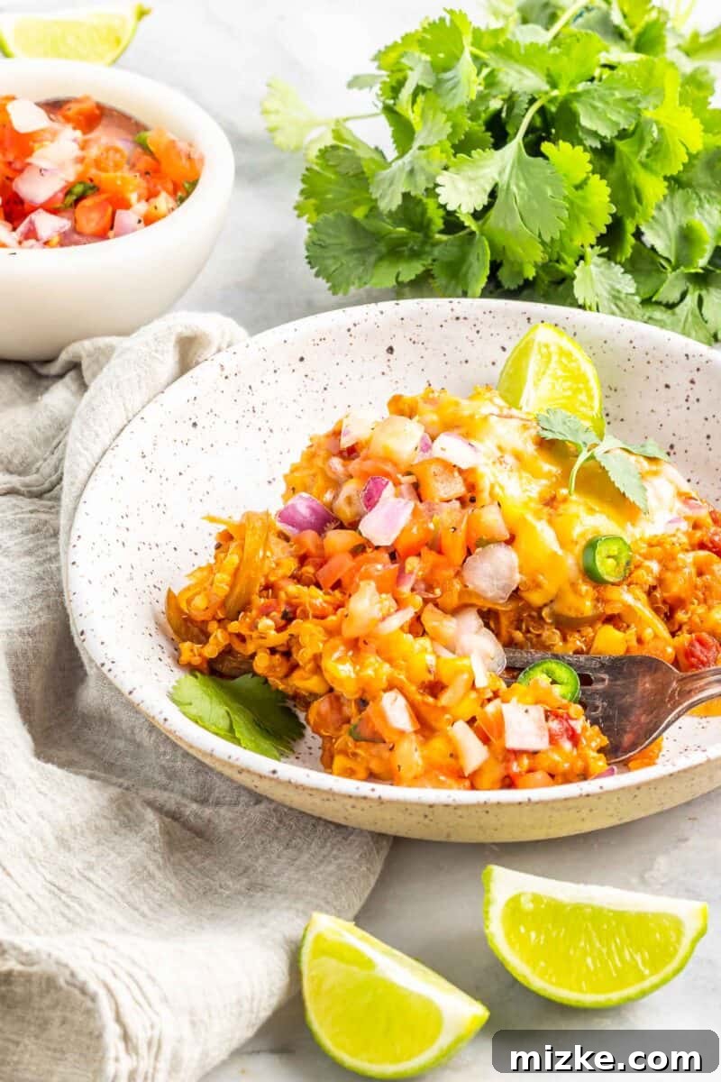 Slow Cooker Fiesta Quinoa Bake 9 A beautifully garnished Slow Cooker Quinoa Enchilada Casserole, served with fresh lime wedges and cilantro, ready to be enjoyed.