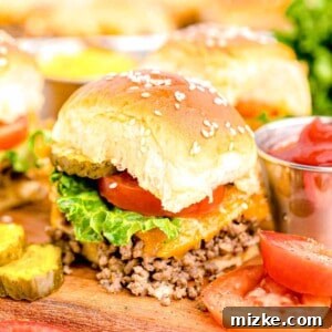 Pint-Sized Patty Perfection 12 A cheeseburger slider is showcased alongside vibrant pickle and tomato slices, emphasizing its delicious appeal.