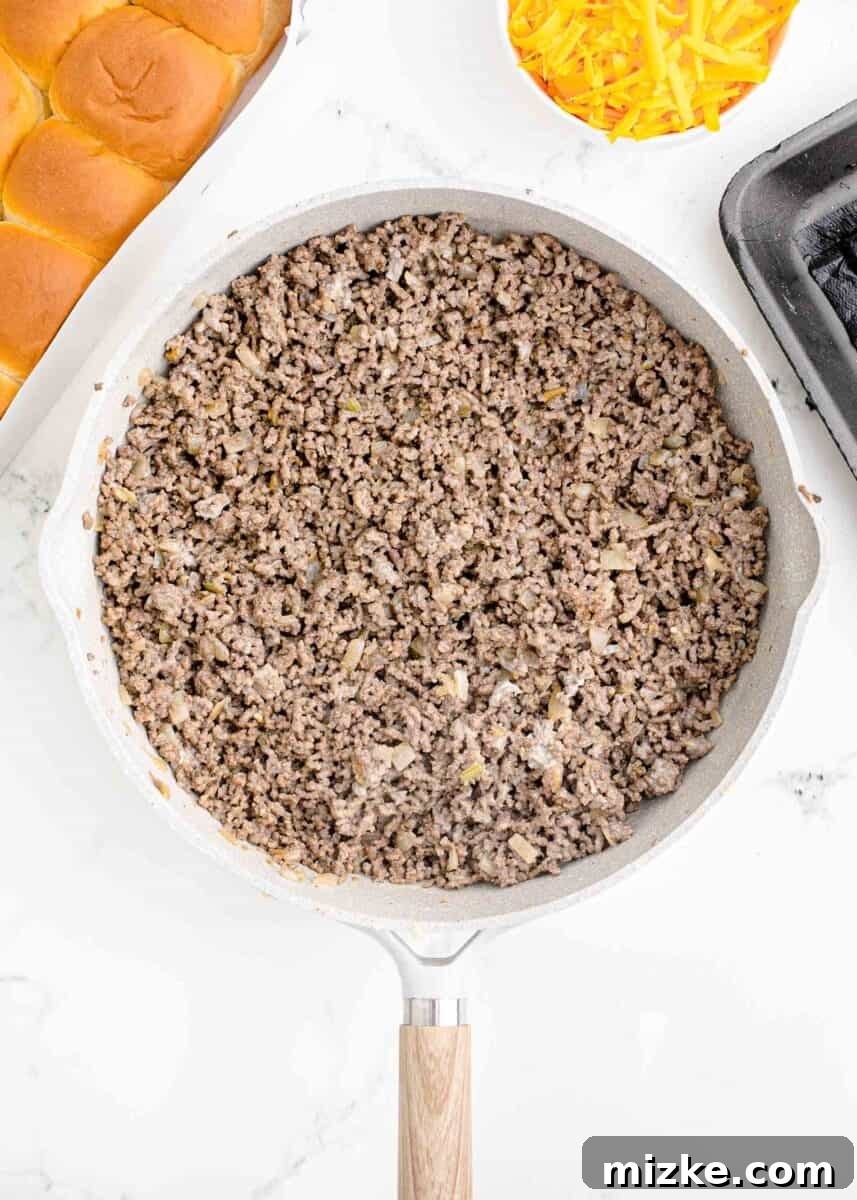 Pint-Sized Patty Perfection 5 Perfectly cooked and crumbled ground beef is presented in a skillet, ready for seasoning.