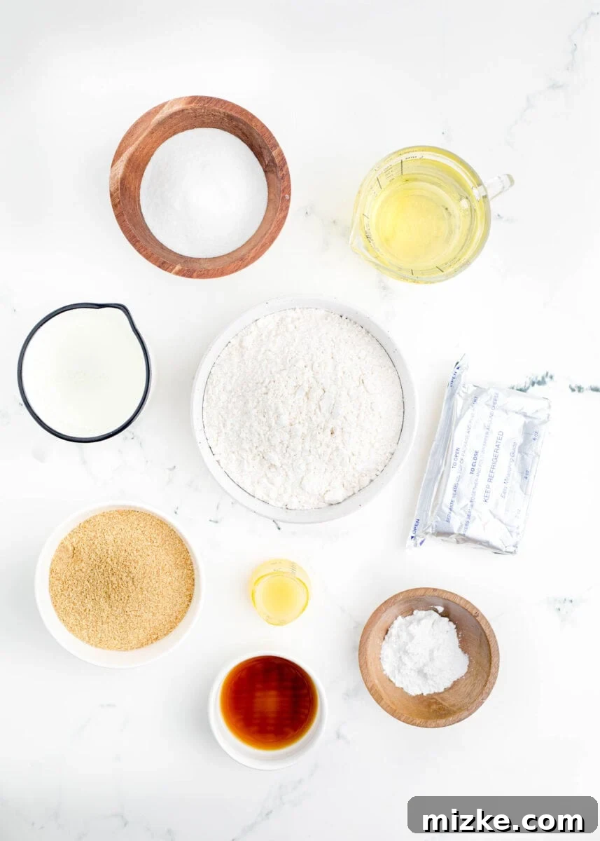 Crispy Cheesecake Poppers 3 The essential ingredients for crafting delicious fried cheesecake bites are neatly arranged on a pristine countertop, ready for preparation.