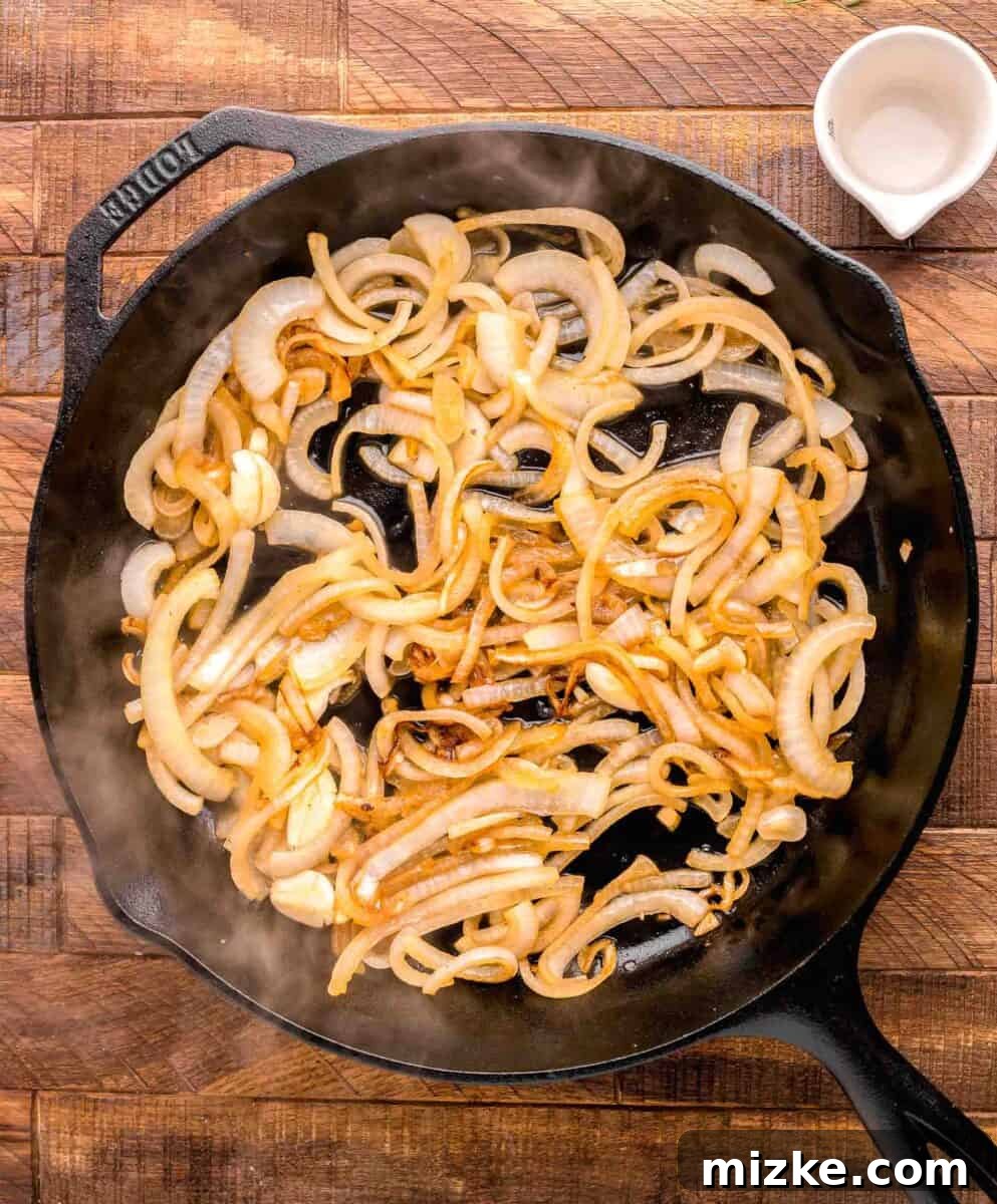 Juicy Oven-Roasted Pork Chops 5 Finely sliced onions are actively cooking and softening in a hot skillet, beginning to caramelize and turn translucent.