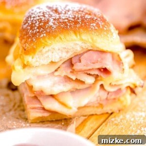 A Monte Cristo slider is presented on a wooden surface, ready to be enjoyed.
