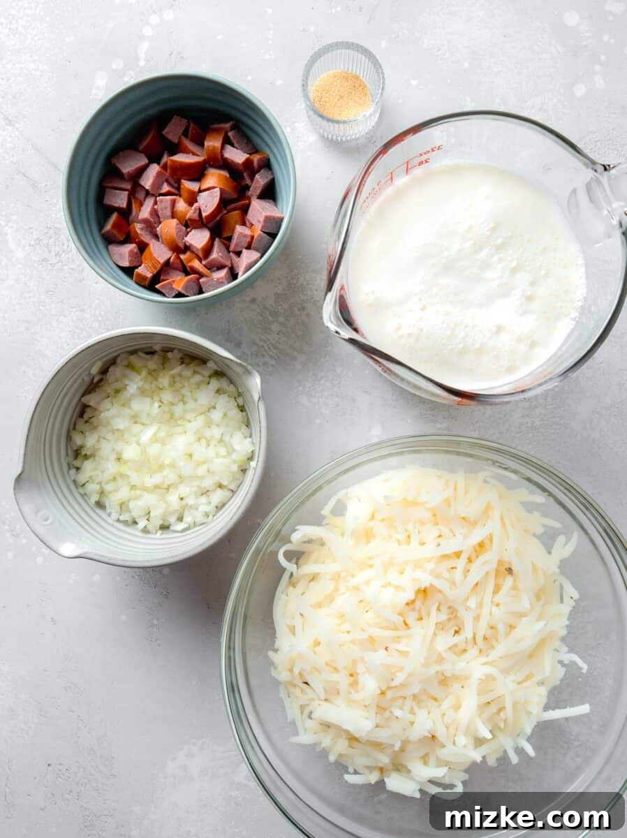 A beautiful flat lay photograph displaying all the fresh ingredients required for making the egg white breakfast casserole, including savory sausage, finely diced onions, shredded potatoes, cartons of liquid egg whites, and a bowl of shredded cheese, perfectly arranged for preparation.