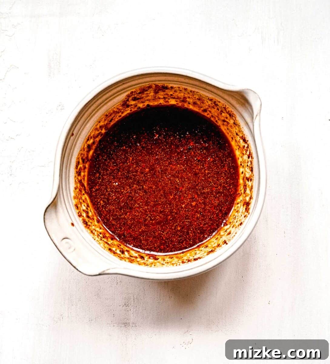 Instant ramen noodles are coated in a full-flavored, spicy sauce in this delicious, quick, and easy buldak ramen recipe. The completed Buldak ramen sauce, a thick, glossy red paste, ready to be tossed with noodles.