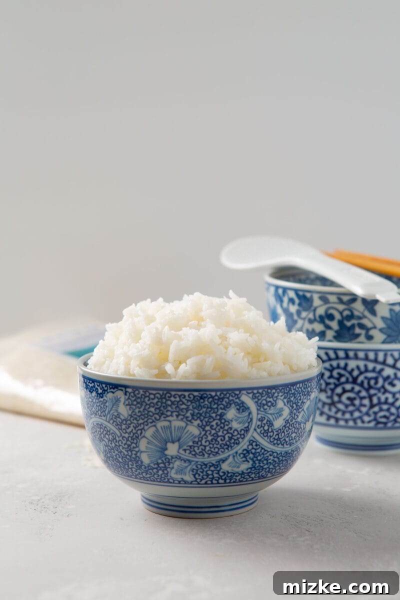 Perfect Instant Pot Jasmine Rice 2 Instant Pot Jasmine rice served in a beautiful blue decorative bowl with other blue bowls in the background