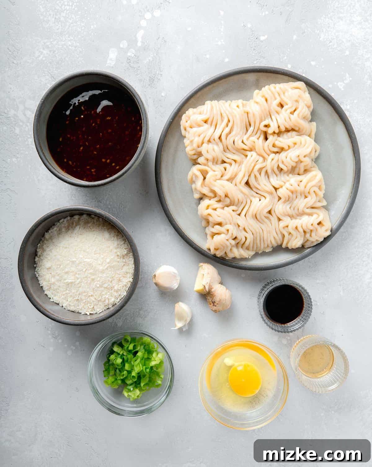 A visual guide to the fresh ingredients required for crafting homemade juicy teriyaki chicken meatballs, from grated ginger to salty soy sauce. A vibrant selection of fresh ingredients laid out for making teriyaki chicken meatballs, showcasing their quality and readiness for preparation.