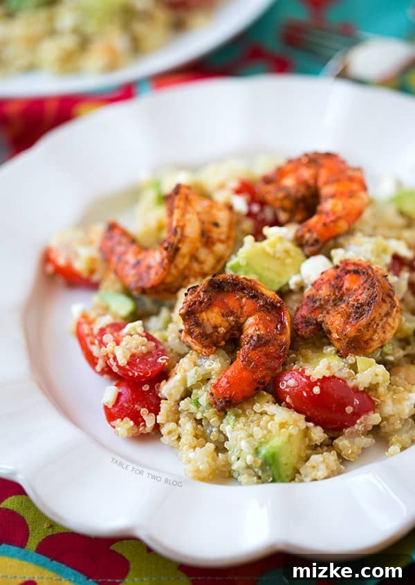 Spicy Grilled Shrimp with Quinoa Salad | tablefortwoblog.com Colorful quinoa salad with fresh ingredients like tomatoes, chickpeas, and avocado.