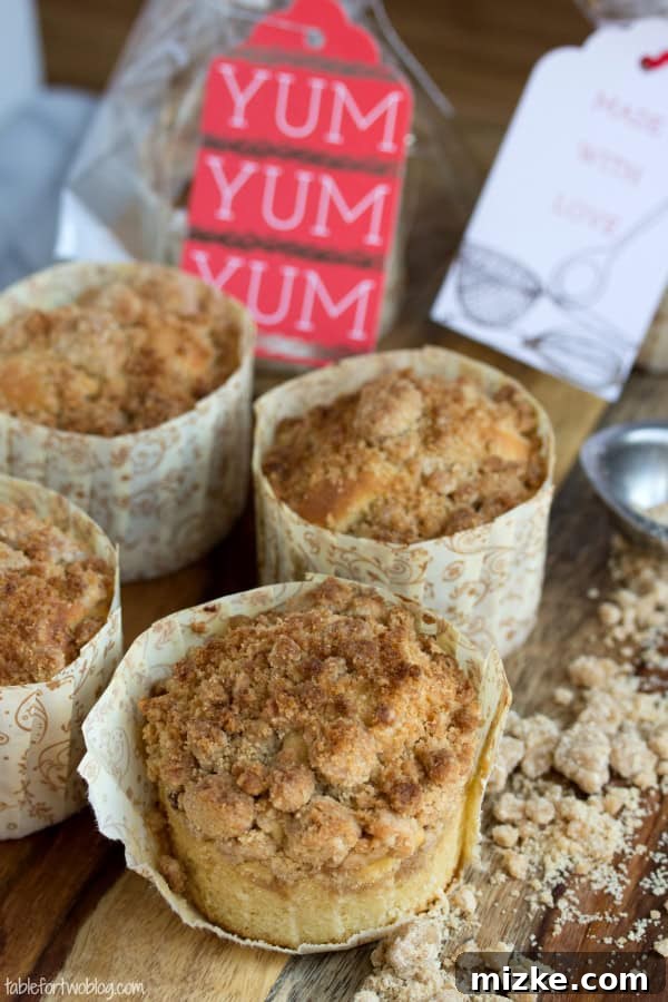 New York-Style Coffee Cake Crumb Muffins from www.tablefortwoblog.com New York-Style Coffee Cake Crumb Muffins displayed on a wooden board, ready to be enjoyed.