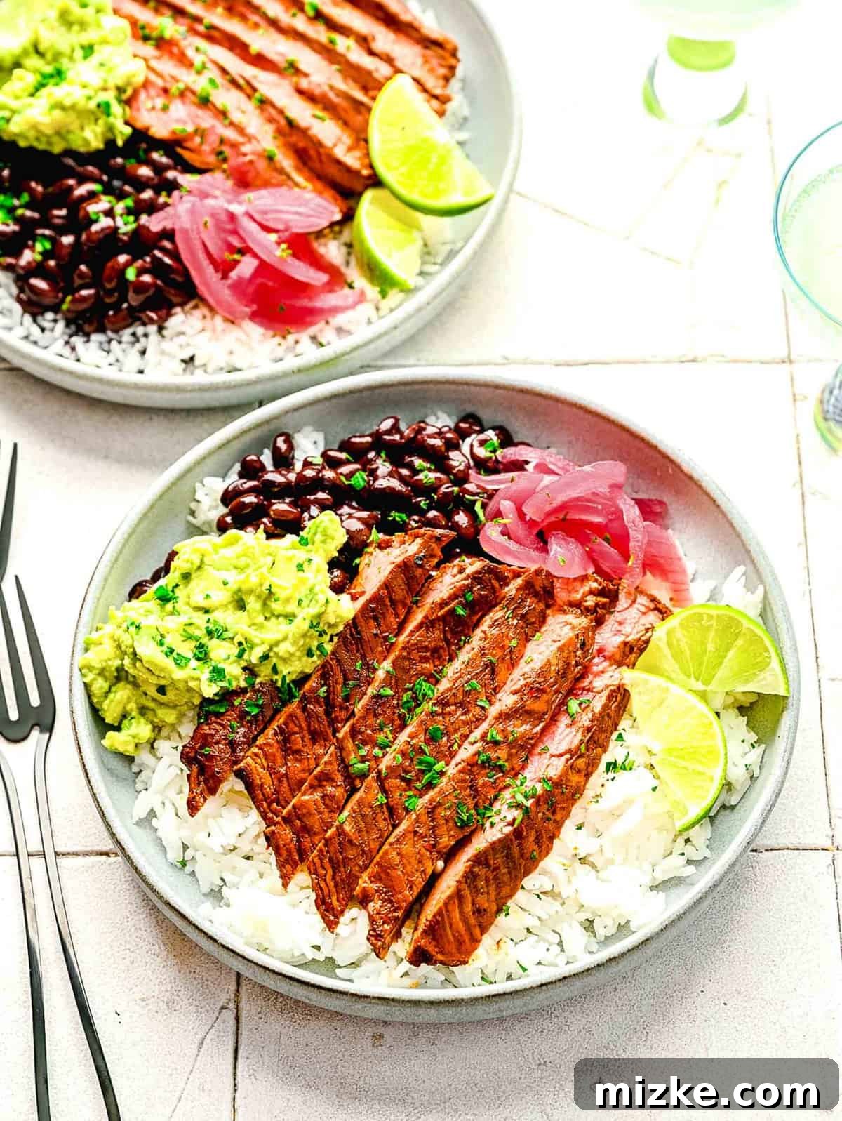Bold Chipotle Guajillo Garlic Steak 2 Garlic guajillo steak served deliciously in colorful burrito bowls.