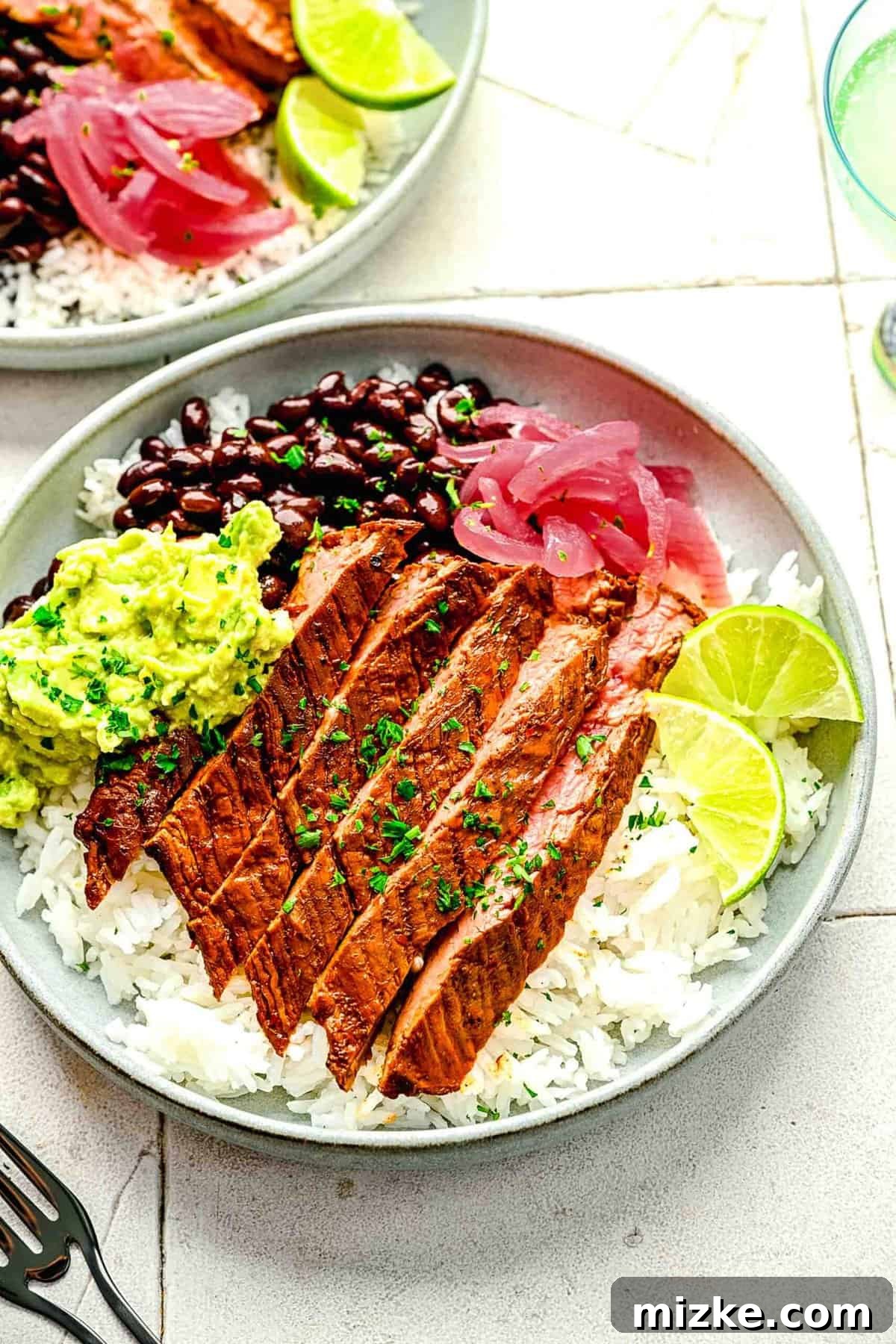 Bold Chipotle Guajillo Garlic Steak 11 Garlic guajillo steak beautifully arranged in multiple burrito bowls.