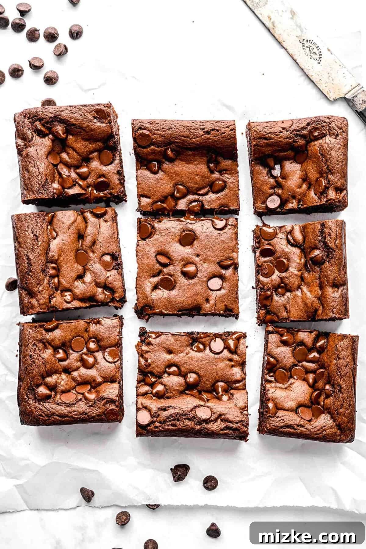 These cake mix brownies turn baking into a walk in the park. Made with 5 ingredients in 30 minutes, they're sure to become a new favorite. Cake mix brownies cut into squares, showcasing their fluffy texture and chocolate chips.