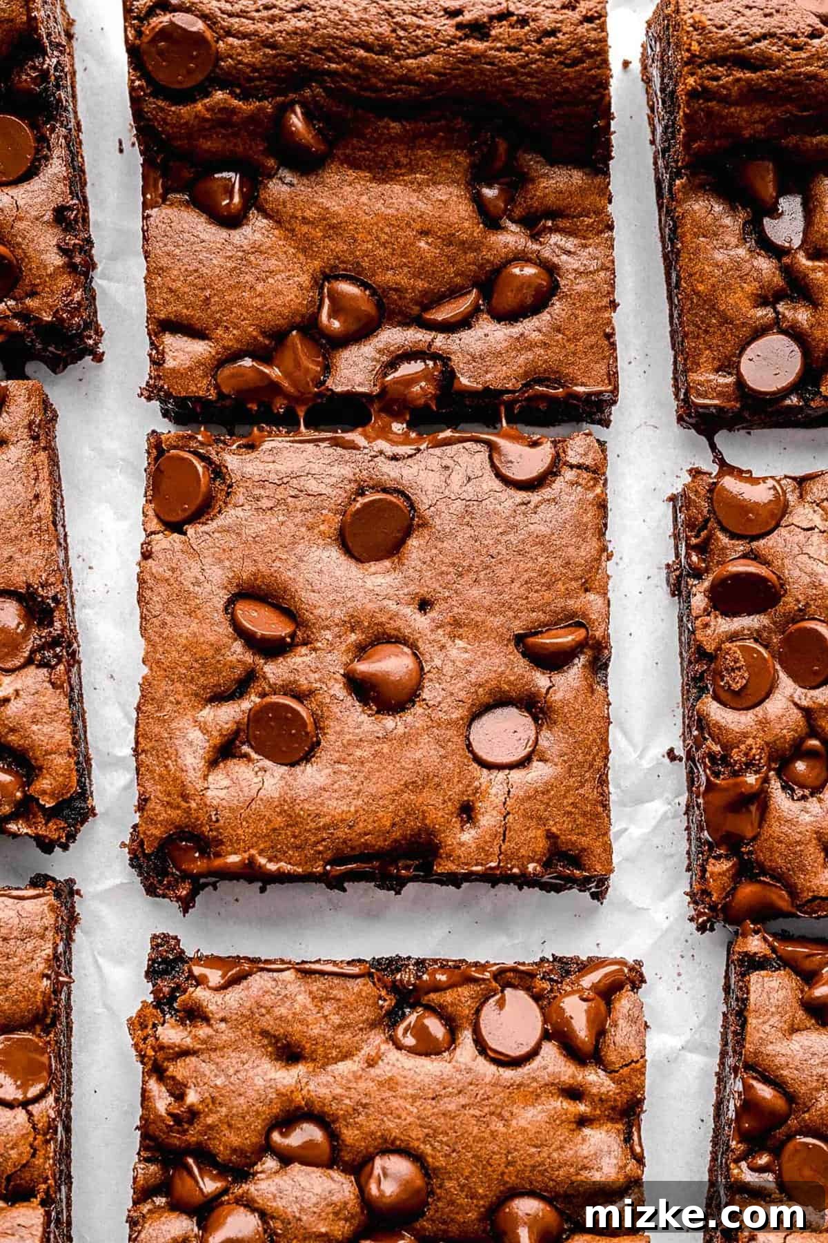 These cake mix brownies turn baking into a walk in the park. Made with 5 ingredients in 30 minutes, they're sure to become a new favorite. Closeup of perfectly sliced cake mix brownies, showing their even texture and generous chocolate chips.