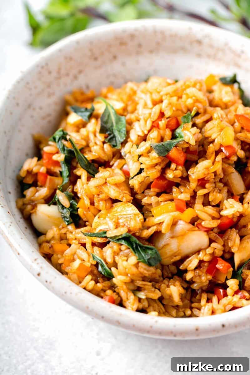 thai basil fried rice in a speckled bowl