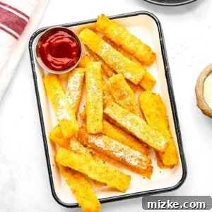 Polenta fries on a plate with ketchup.