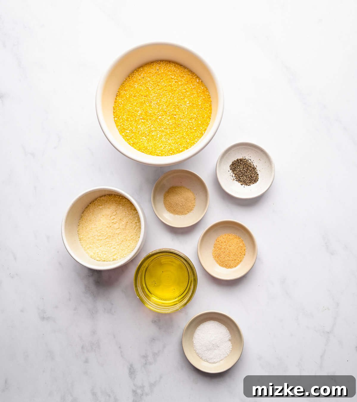 These polenta fries are made from cheesy polenta cut into strips, brushed with olive oil, and baked to crispy golden brown. Ingredients for baked polenta fries.