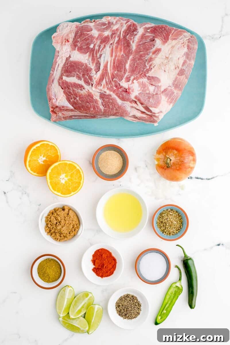 Melt-Away Slow Cooker Pork Carnitas 3 A variety of fresh ingredients for slow cooker pork carnitas are neatly arranged on a white surface.