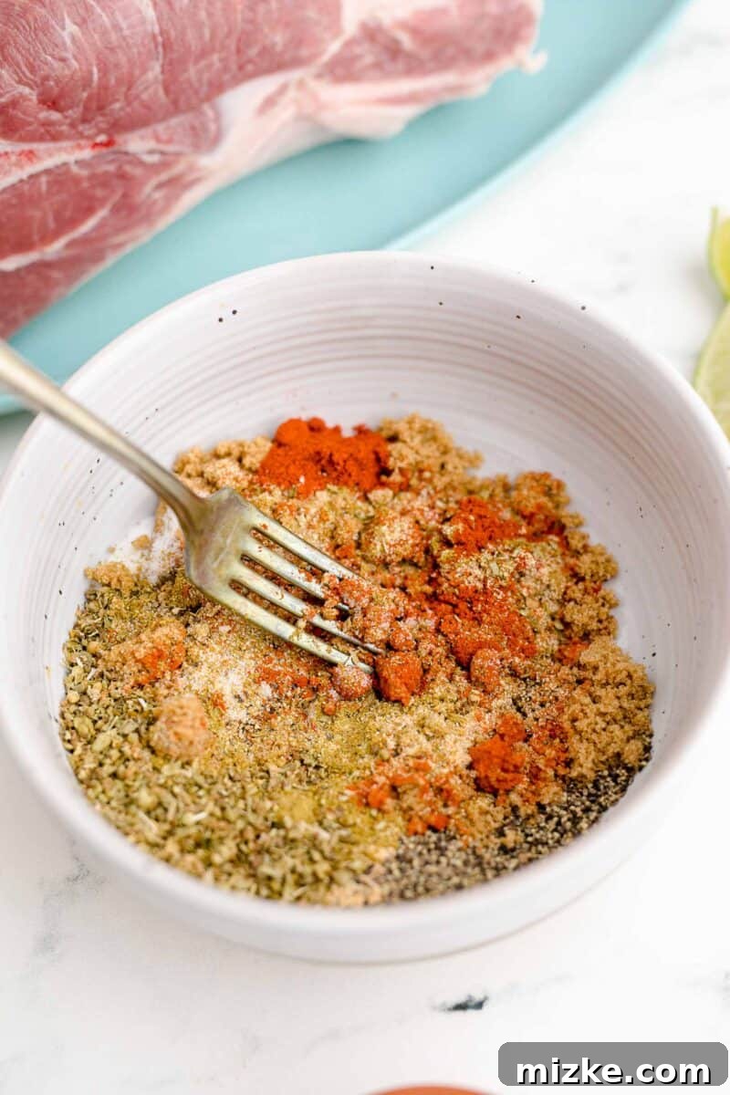 Melt-Away Slow Cooker Pork Carnitas 4 Seasonings are being thoroughly mixed together with a fork in a small bowl.