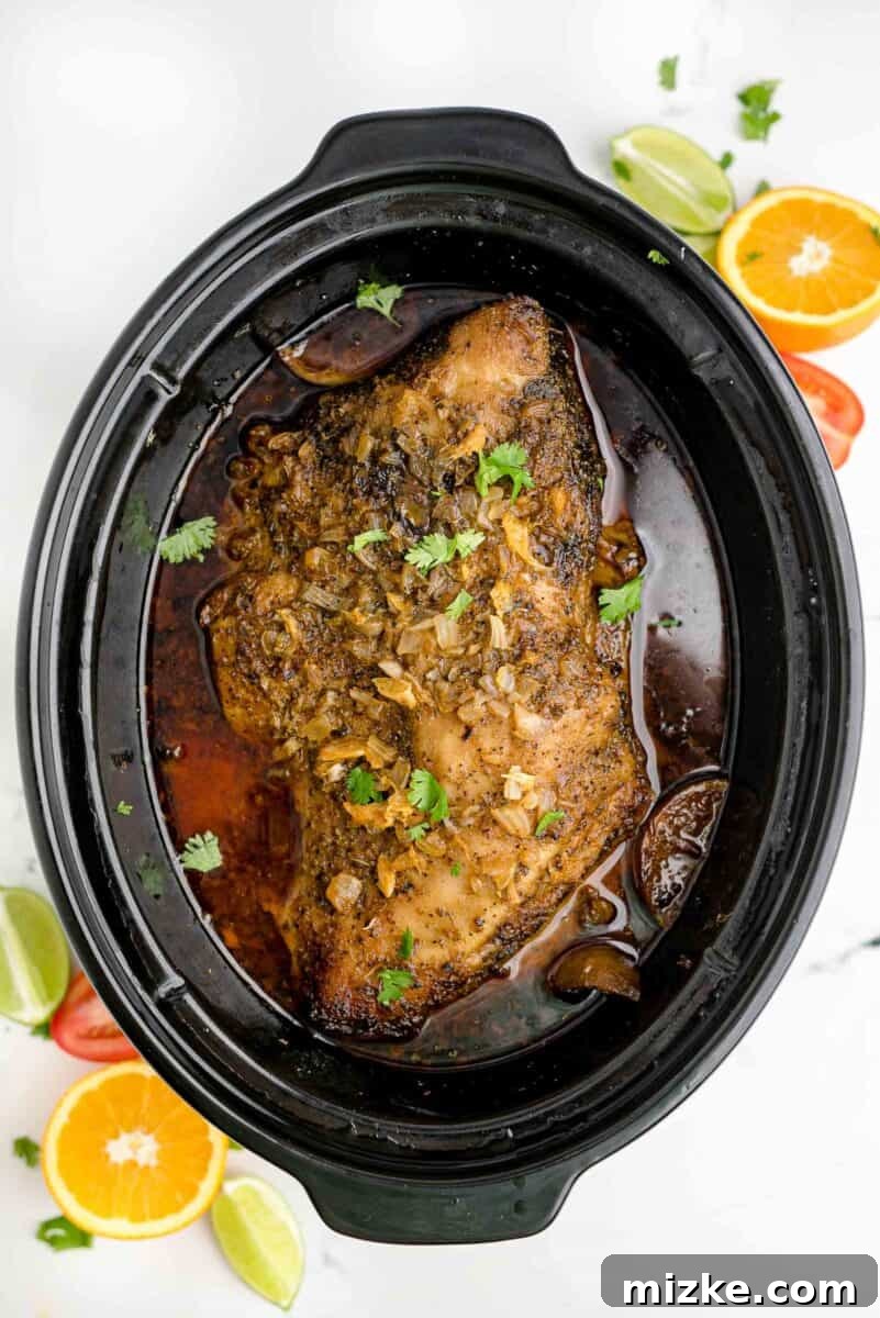 Melt-Away Slow Cooker Pork Carnitas 9 Perfectly cooked, tender pork is presented in a slow cooker, ready for the next step.