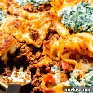 Effortless Sheet Pan Lasagna 15 sheet pan lasagna with a metal spatula in the center
