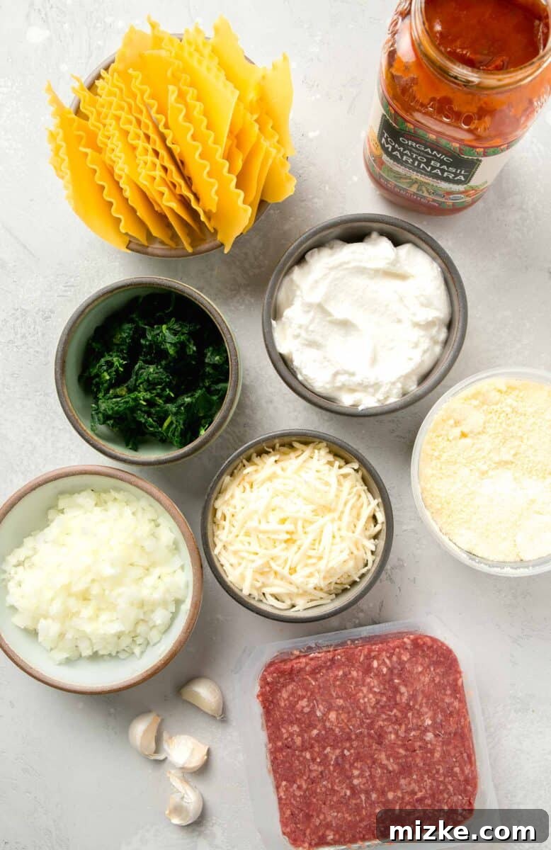 Effortless Sheet Pan Lasagna 3 ingredients for sheet pan lasagna laid out on a kitchen counter