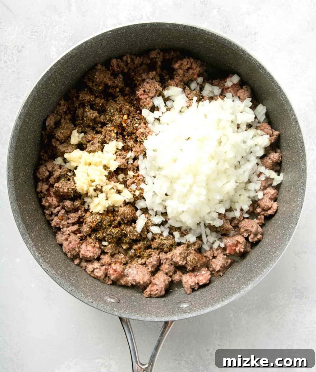 Effortless Sheet Pan Lasagna 7 onions, garlic, and seasonings added to the cook ground beef in nonstick skillet
