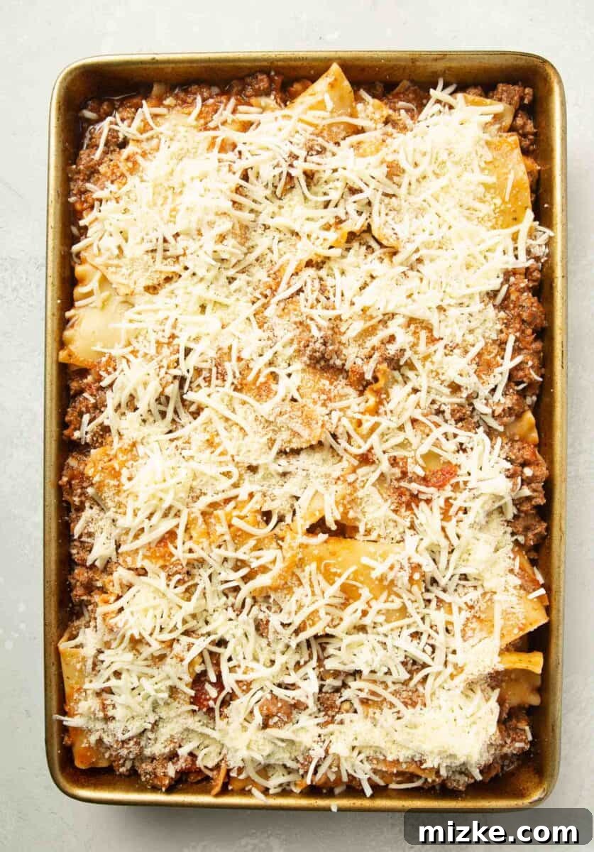 Effortless Sheet Pan Lasagna 10 assembled sheet pan lasagna on a rimmed baking sheet prior to baking