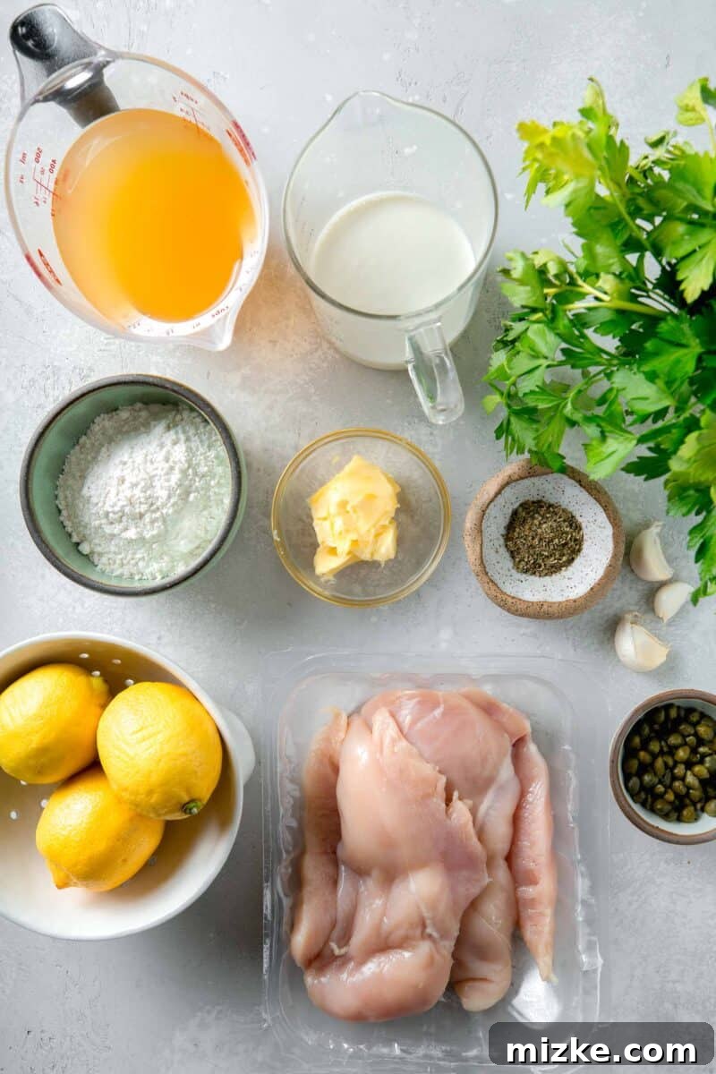 Velvety Lemon Chicken Piccata 4 A curated selection of fresh ingredients neatly arranged on a countertop, including boneless skinless chicken breasts, lemons, fresh parsley, capers, butter, garlic, and flour, ready for making creamy lemon chicken piccata.