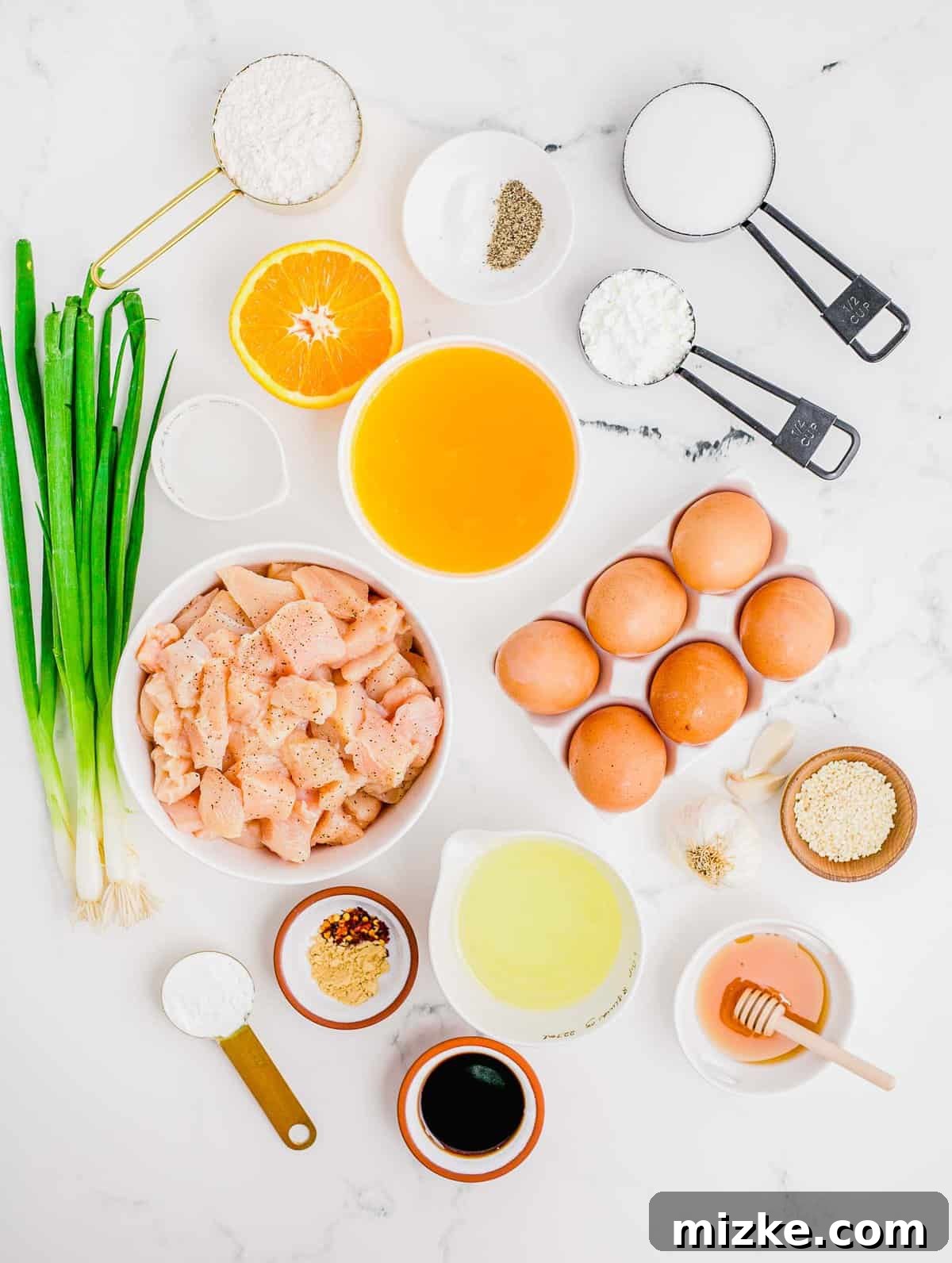 Fresh, high-quality ingredients are the secret to the best homemade orange chicken recipe. A beautifully arranged selection of fresh ingredients for orange chicken, including chicken breast, oranges, ginger, garlic, soy sauce, and spices.