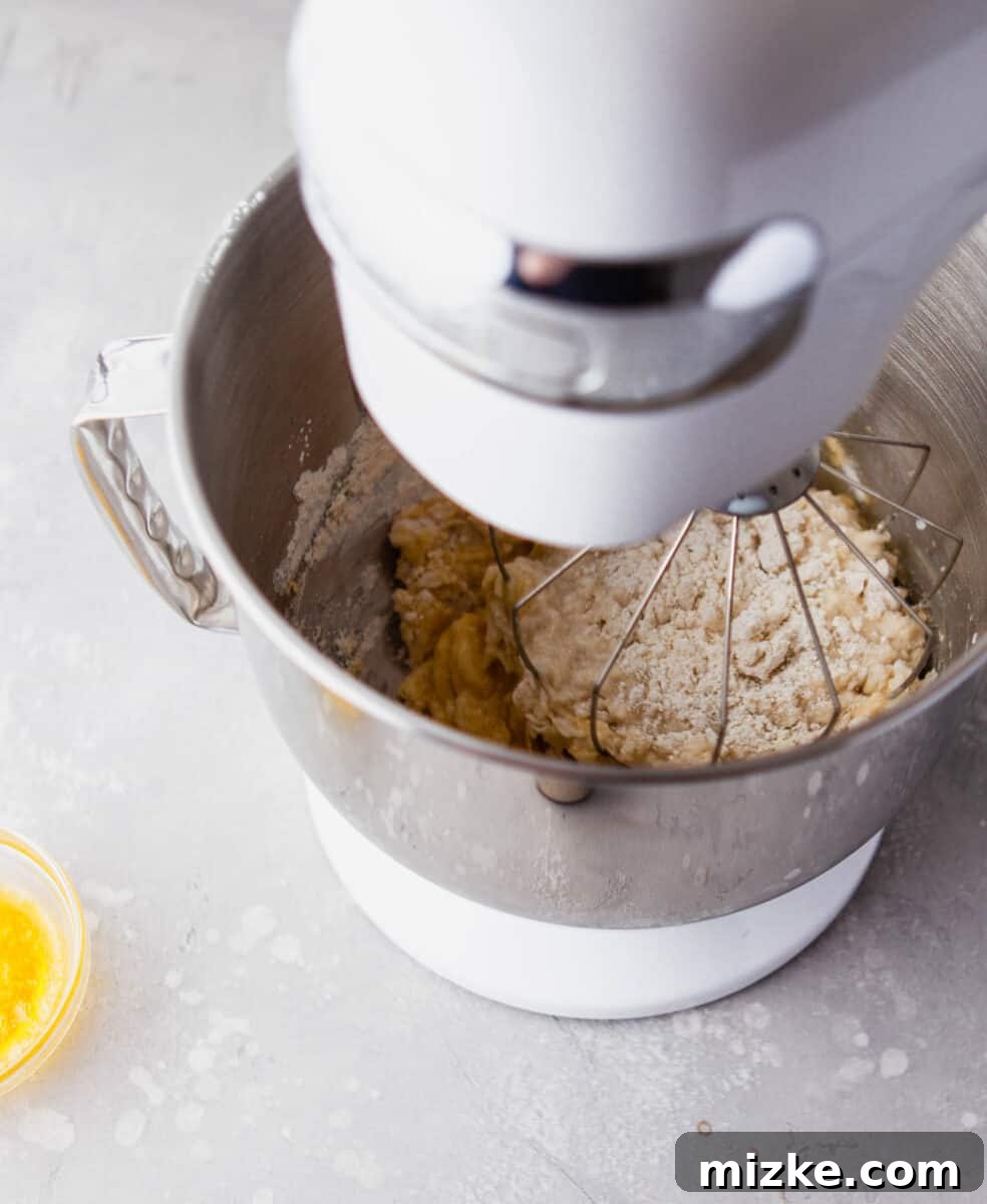 Perfectly Baked Vanilla Delights 5 A stand mixer bowl contains a perfectly blended, smooth donut batter, ready for piping.