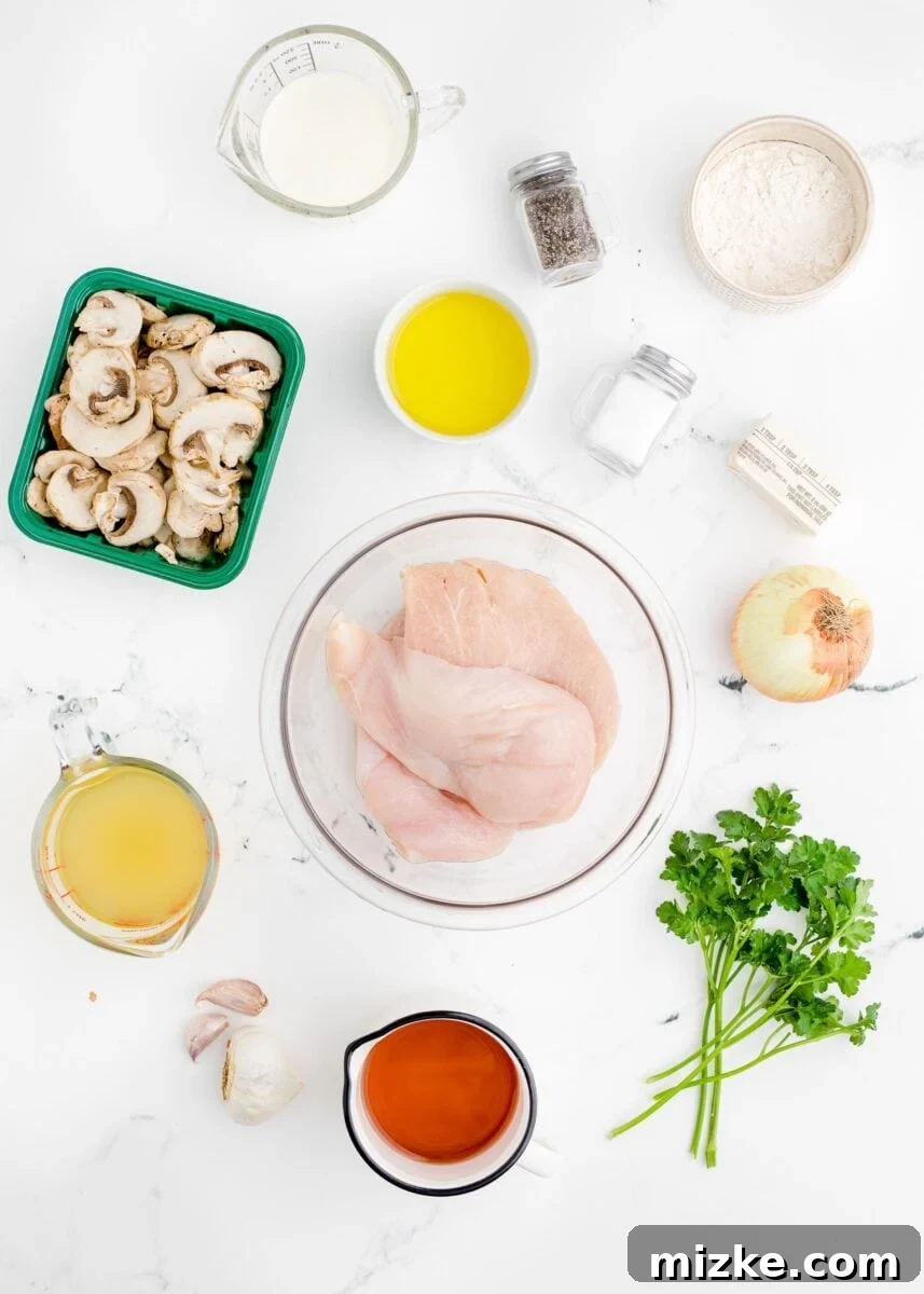 Simple Weeknight Chicken Marsala 3 All the fresh ingredients required for making chicken marsala are neatly arranged on a pristine white kitchen countertop.