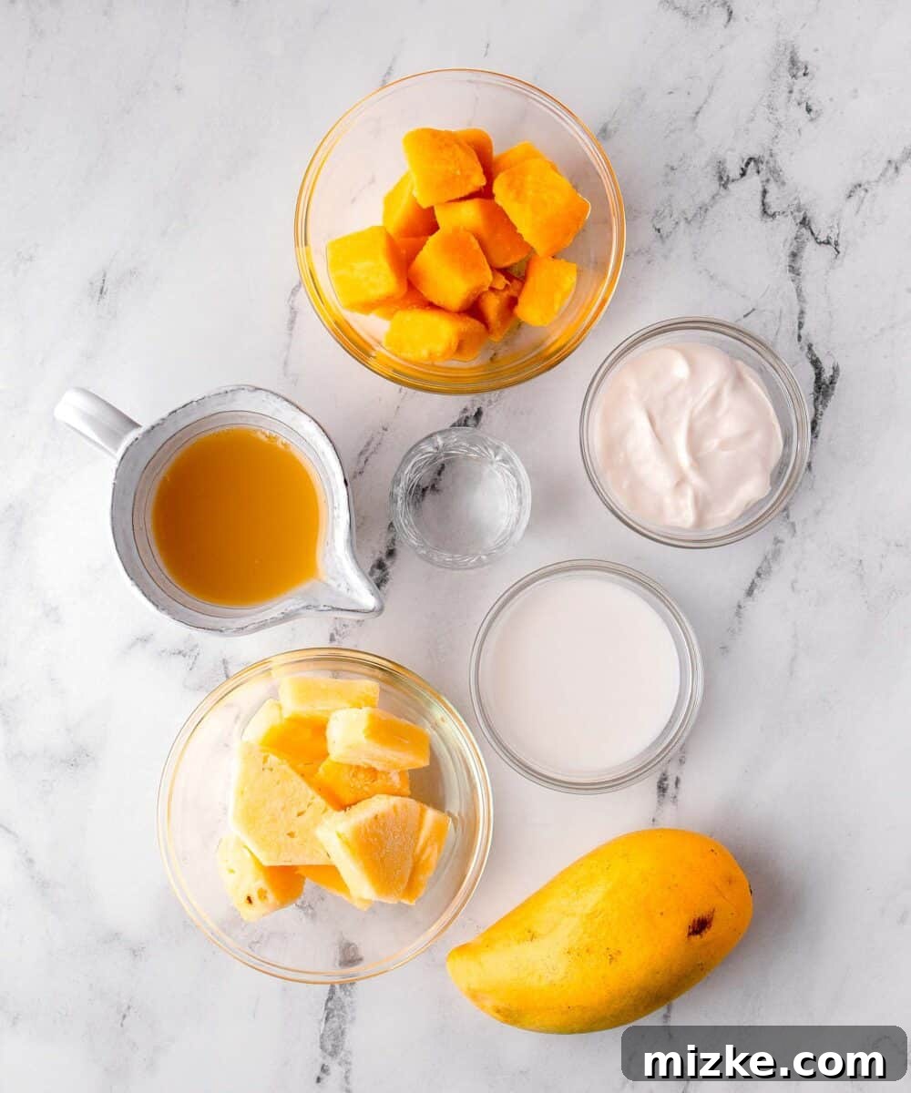 Velvet Mango Sunset 3 All fresh ingredients for a Mango Colada are neatly arranged on a pristine marble countertop, ready for blending.