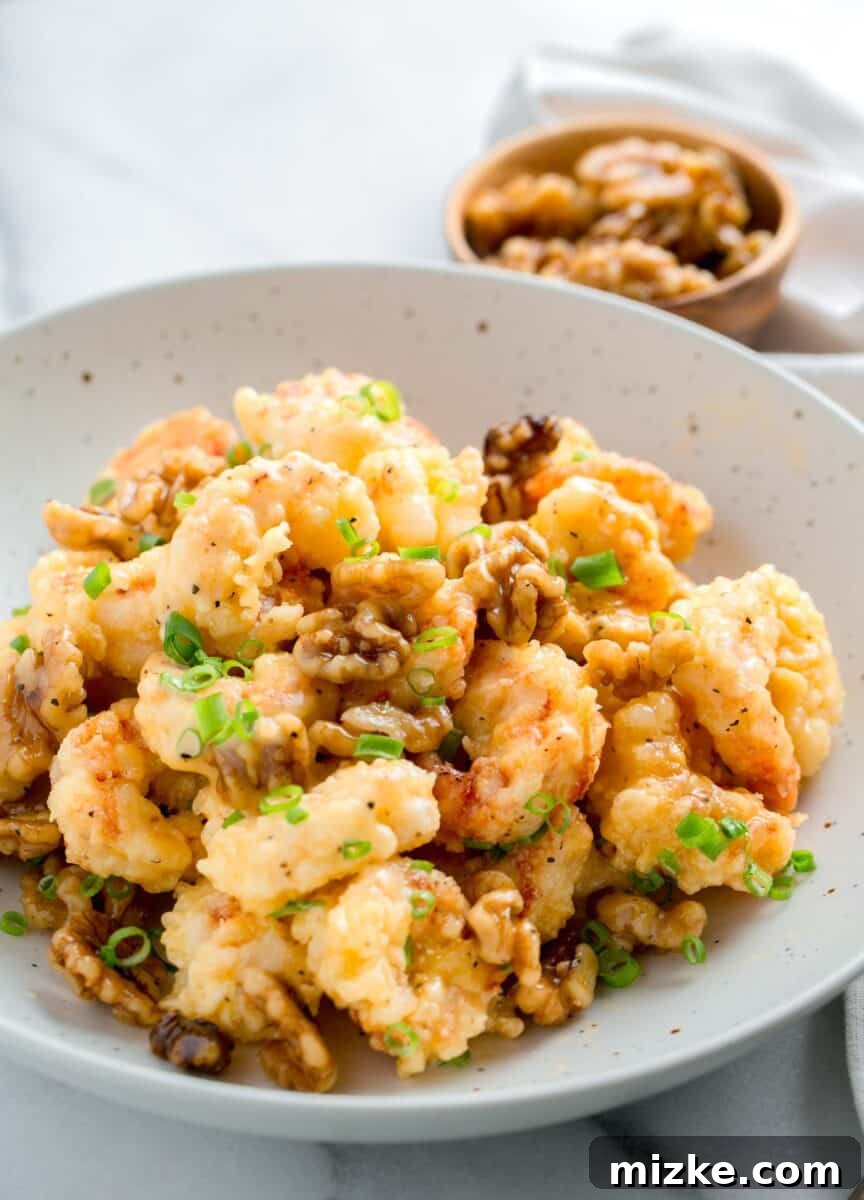 Crispy Honey Walnut Shrimp 13 Honey walnut shrimp plated in a large speckled bowl, ready to be enjoyed.