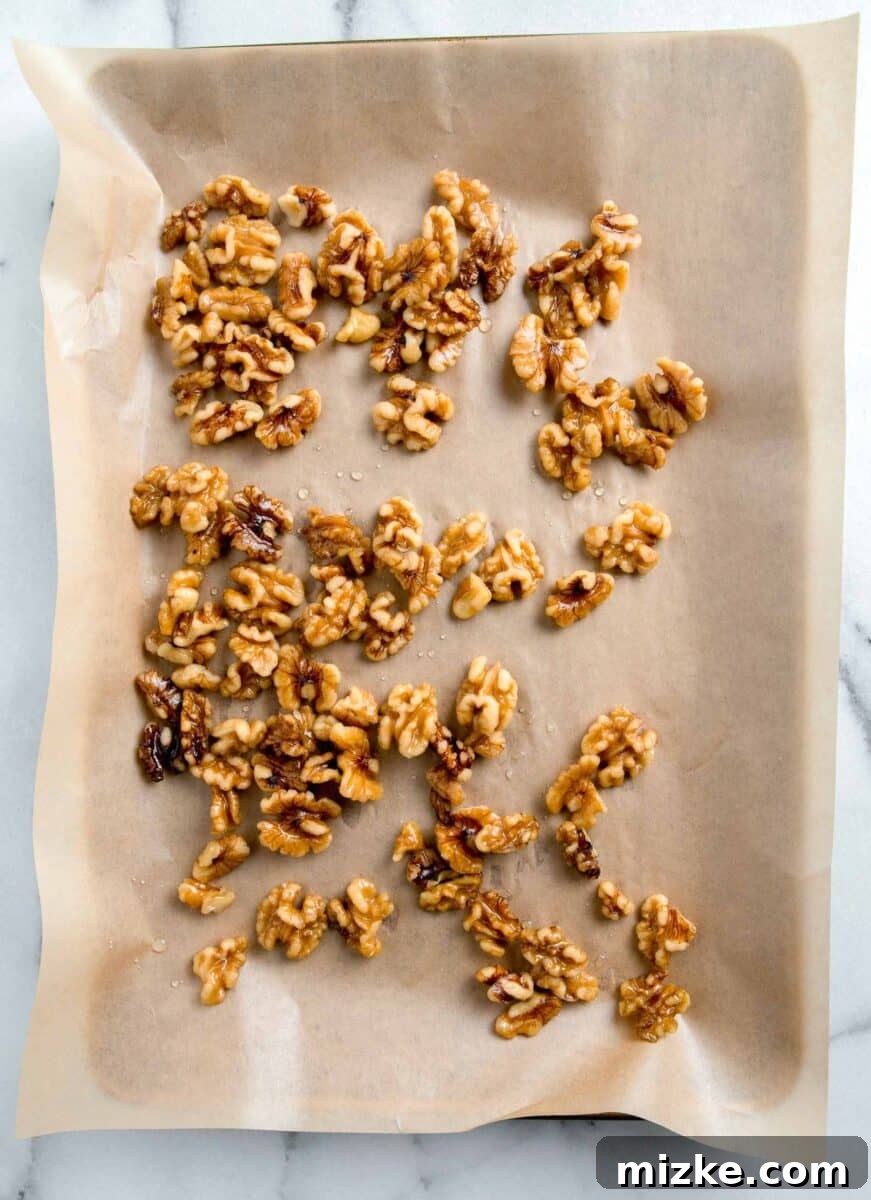 Crispy Honey Walnut Shrimp 6 Candied walnuts spread evenly on a parchment paper-lined baking sheet to cool and harden.