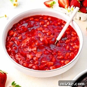 Luscious Strawberry Cake Filling 2 Strawberry cake filling in a bowl near fresh strawberries.