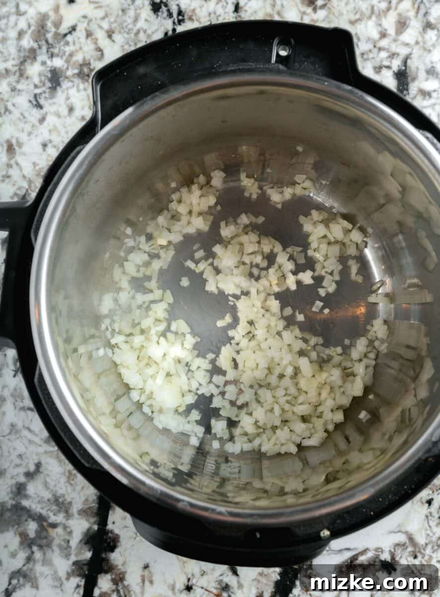 diced onions being sautéd in instant pot