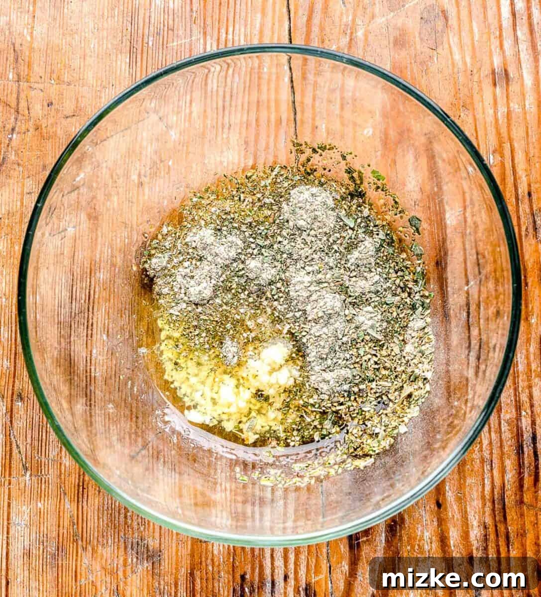 Greek seasoning in a clear bowl on a wooden table