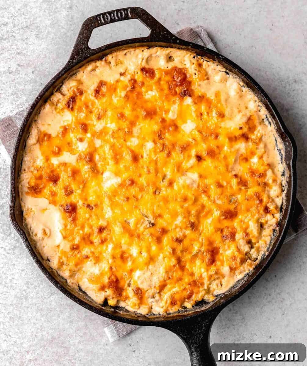 melted cheese on top of the baked corn dip in a skillet