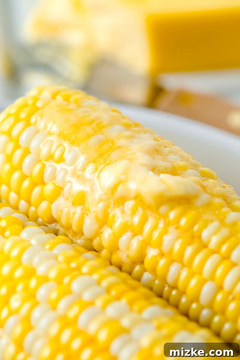 Instant Pot Corn Perfection 6 melted butter on top of corn on the cob