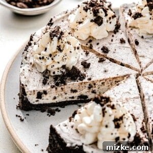 Oreo pie cut into slices on a serving plate, showing its perfect layers.