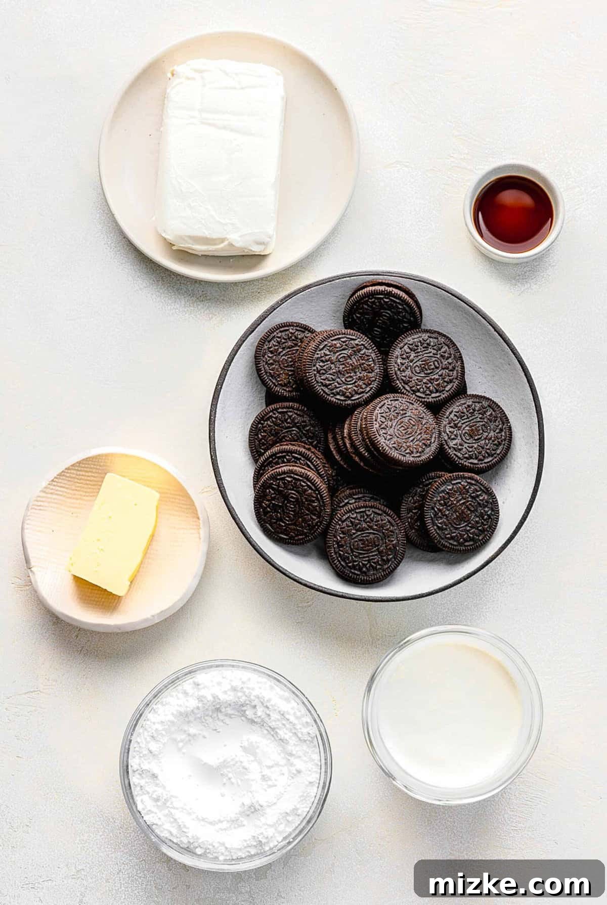 Various ingredients for an Oreo pie separated into bowls, ready for mixing.